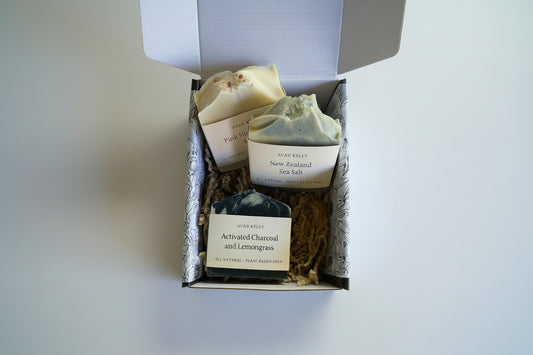 Three soaps in a decorative box with natural elements around